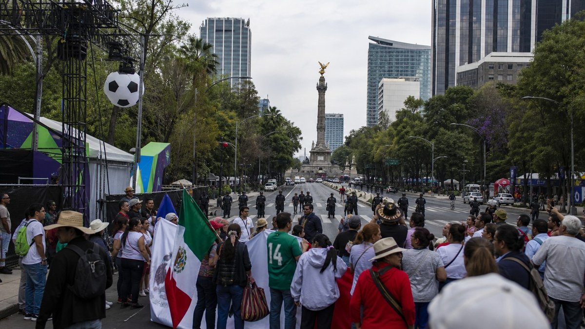 Manifestantes em avenida da Cidade do México perto de decoração da Copa do Mundo.
